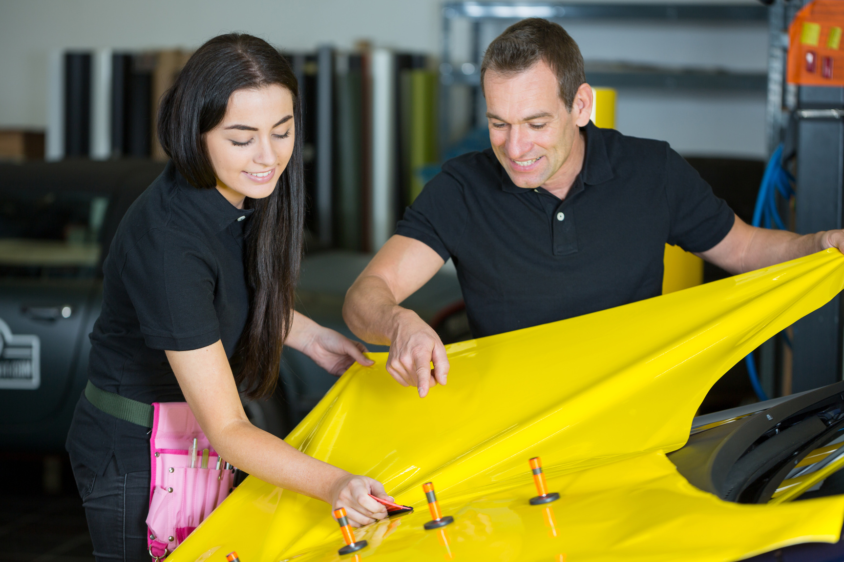 Car wrapping specialists straightening vinyl foil or film